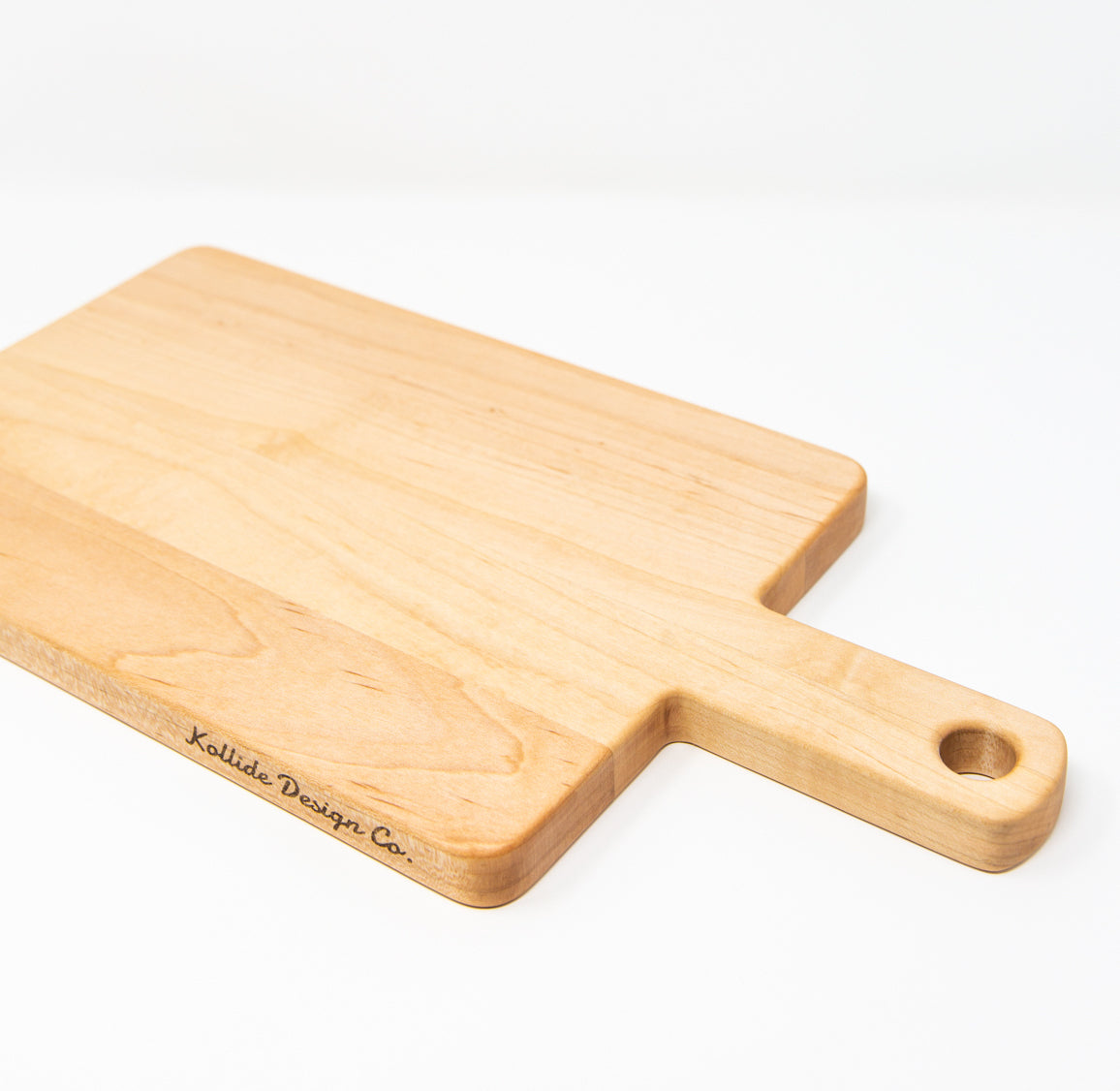 Small wood charcuterie board, made of light blonde Maple, with a timeless rectangular shape and a straight handle.
