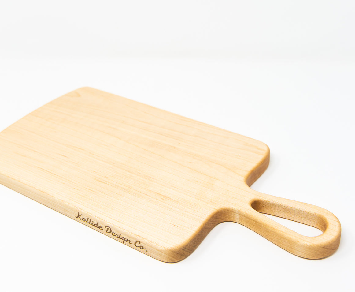 Extra small wood charcuterie board, made light blonde Maple, with smooth curves and a unique teardrop handle.
