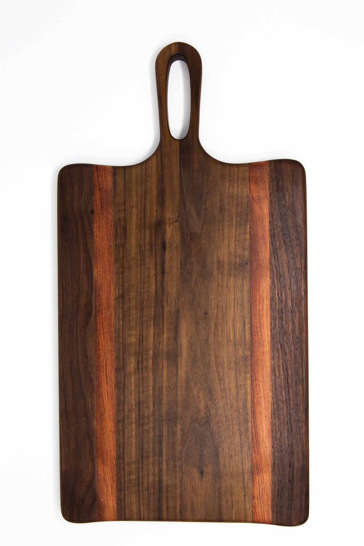 Medium size wood charcuterie board, made of a dark Walnut and two strips of dark reddish-brown Bubinga, with unique looped handle and exaggerated curves.