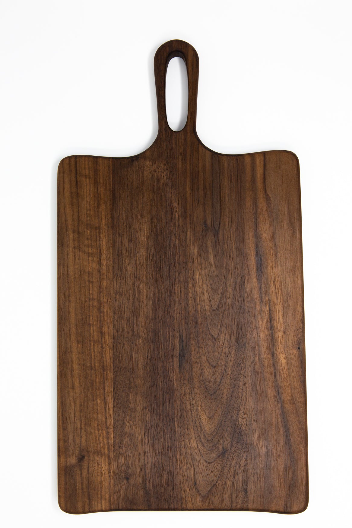 Medium size wood charcuterie board, made of a dark Walnut, with unique looped handle and exaggerated curves.