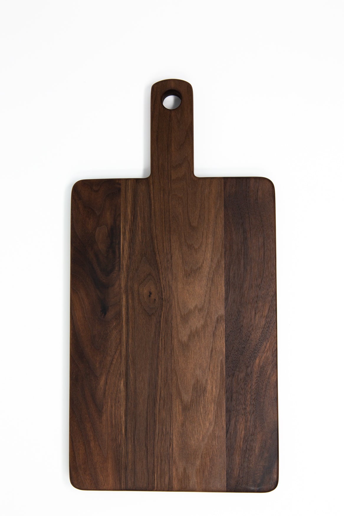 Small wood charcuterie board, made of dark Walnut, with a timeless rectangular shape and a straight handle.