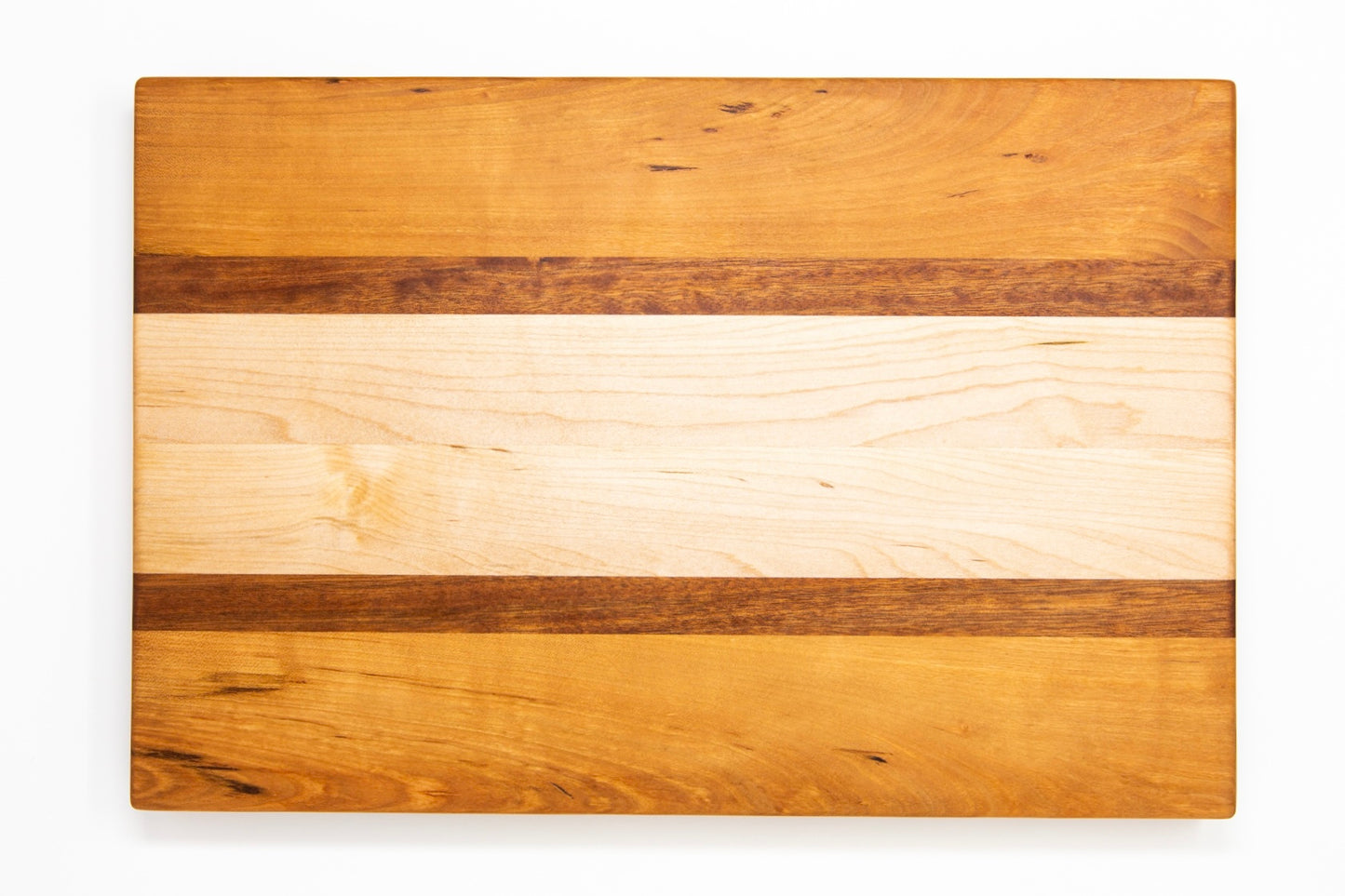 Large size wood cutting board, made of golden-brown Cherry, dark reddish-brown Sapele and light blonde Maple, with side handles.