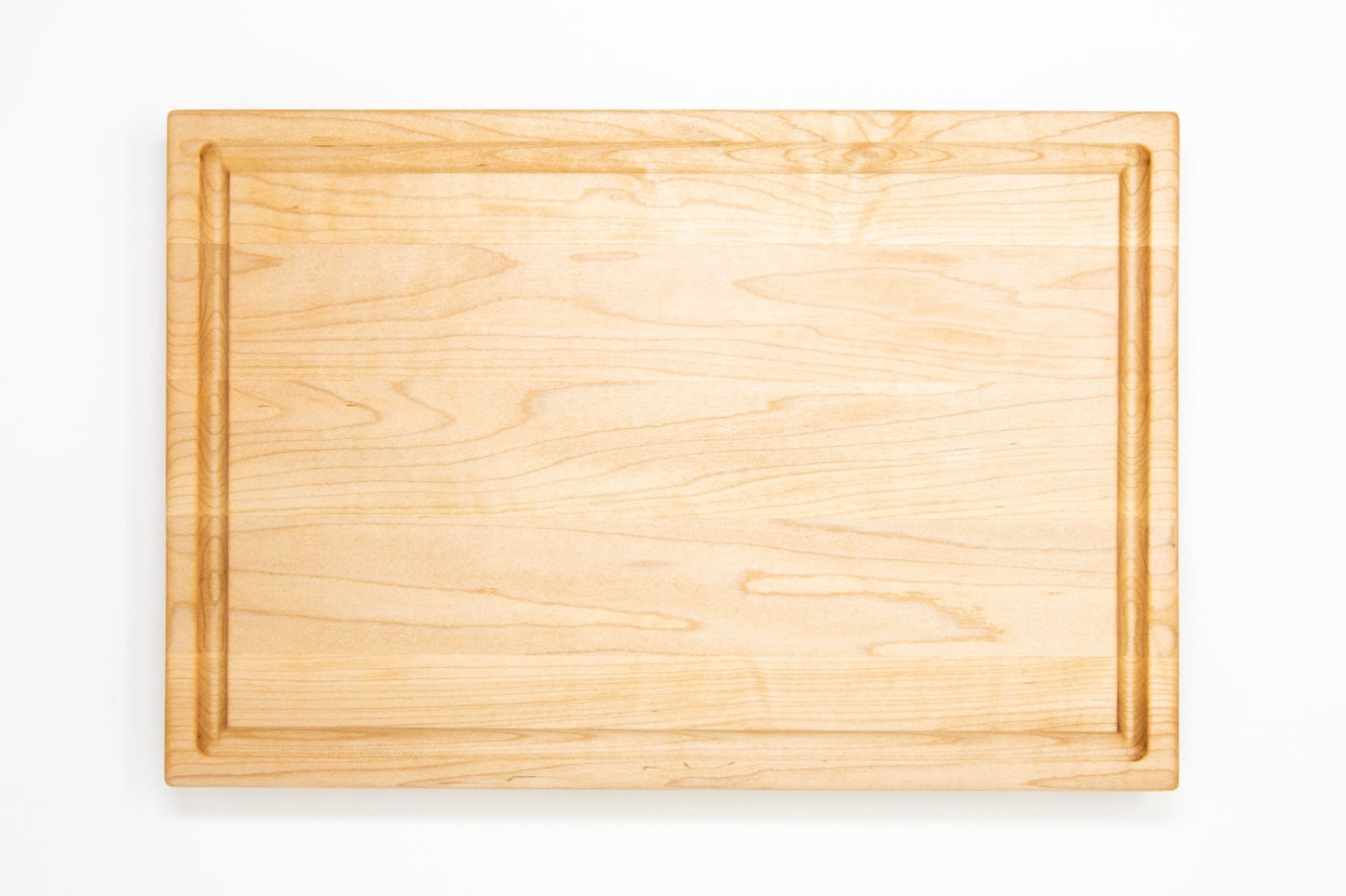 Extra large wood cutting board, made of light blonde Maple, with a juice groove and side handles.