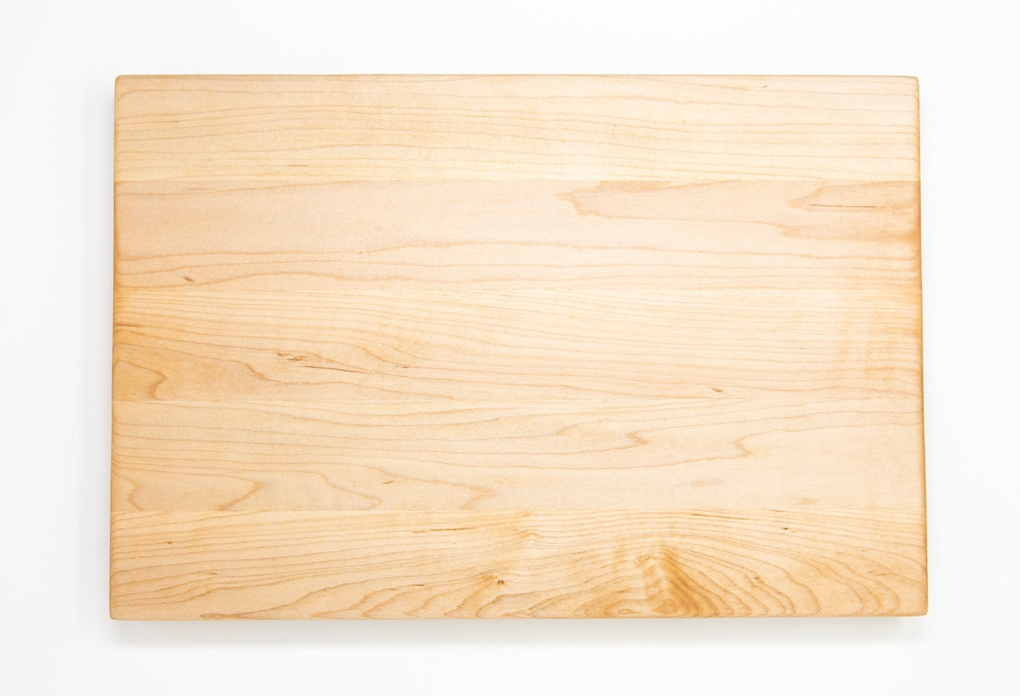 Extra large wood cutting board, made of light blonde Maple, with side handles.