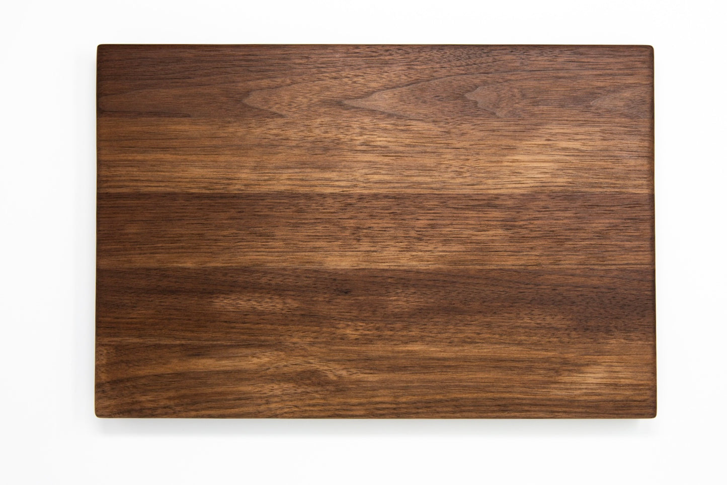 Extra large wood cutting board, made of dark Walnut, with side handles.