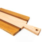 Large size wood charcuterie board, made of golden-brown Cherry, reddish brown Sapele and a center piece of light blonde Maple with a slightly tapered handle and a long rectangular body.