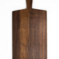 Large size wood charcuterie board, made of dark Walnut, with a slightly tapered handle and a long rectangular body.