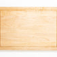 Medium size wood cutting board, made of light blonde Maple, with a juice groove and side handles.