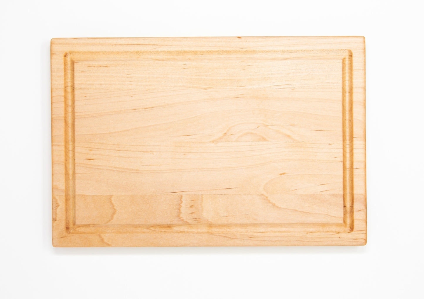 Small wood cutting board, made of light blonde Maple, with a juice groove and side handles.